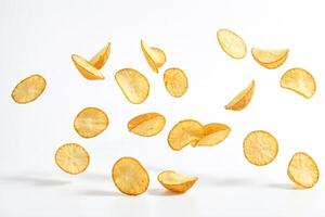 Crispy Potato Chips Falling on a White Background photo