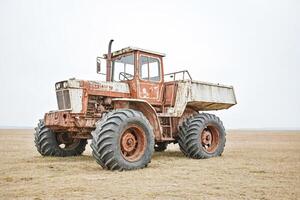Rusty Old Tractor in a Field photo