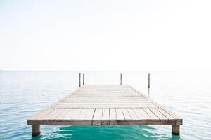 Wooden Dock Extending Over Calm Water photo