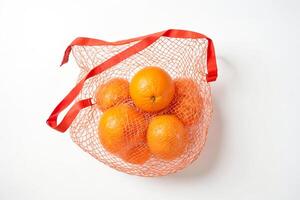 Oranges in a Red Mesh Bag photo