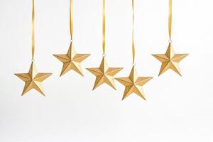 Five Gold Stars Hanging from Ribbons Against a White Background photo