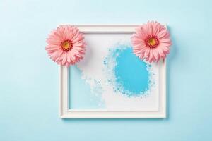 Pink Flowers and White Frame on a Light Blue Background photo