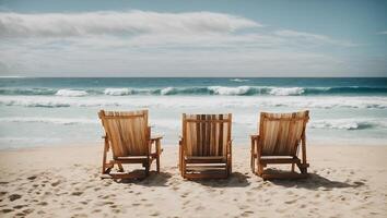 Wooden chairs on a beach with waves crashing in the background photo
