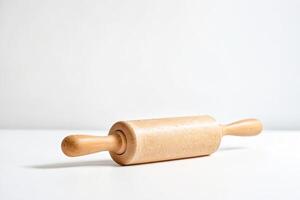 Wooden rolling pin on white background photo