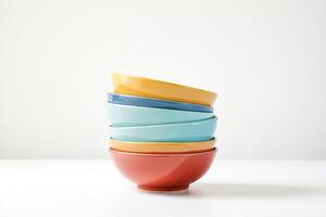 Stack of colorful bowls on white background photo