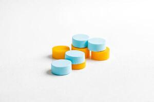 Stack of Blue and Yellow Round Objects on White Background photo