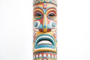 Close-up of a Colorful Totem Pole with a Face Carving photo