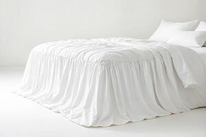 White Bedding with Ruffled Skirt on White Background photo