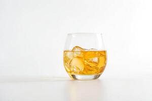 Glass of whiskey with ice on a white background photo