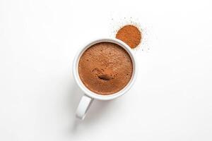 Top View of a Cup of Hot Chocolate with Cocoa Powder on a White Background photo