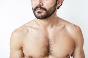 Close-up of a man's bare chest and beard photo