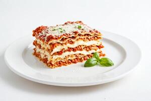 Close-up of a delicious Lasagna with melted cheese and basil leaves on a white plate photo