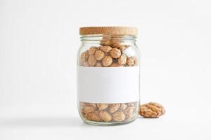 Glass Jar with Cork Lid and Blank Label Filled with Dried Flowers photo