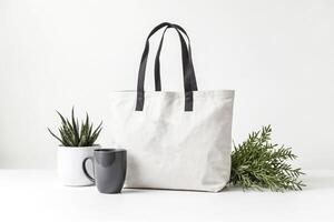 White Canvas Tote Bag Mockup with Green Plants and Grey Mug photo
