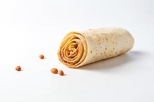 Close up of a rolled up tortilla with filling and peanuts on a white background photo