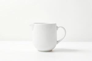 White ceramic pitcher on a white background photo