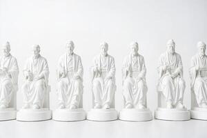 Row of White Statues of Men in Robes photo