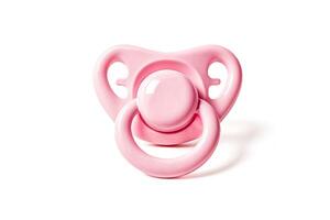 Pink baby pacifier isolated on white background photo