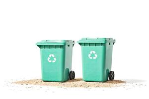 Green recycling bins on sand photo