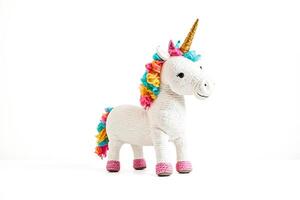 White unicorn toy with rainbow mane and tail on a white background photo