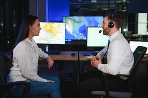 Diverse call center operators team use computers consulting clients in office photo