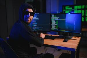 Wanted hackers coding virus ransomware using laptops and computers. Cyber attack, system breaking and malware concept photo