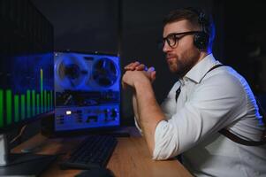 Secret agent listens on the reel tape recorder. Officer wiretapping in headphones. Spying of conversations. Intelligence gathering. Espionage concept photo