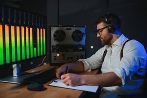 Secret agent listens on the reel tape recorder. Officer wiretapping in headphones. Spying of conversations. Intelligence gathering. Espionage concept photo