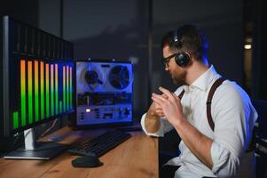 A male spy listens and records conversations on a reel-to-reel tape recorder photo