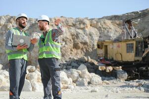 Workers talking in rock quarry photo