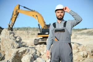 Portrait of a worker standing on the background of a stone quarry photo