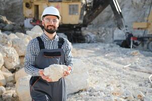 Portrait of a worker standing on the background of a stone quarry photo