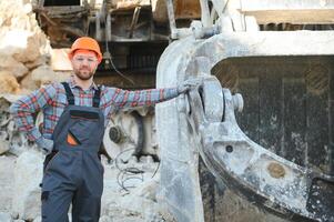 Portrait of a worker standing on the background of a stone quarry photo