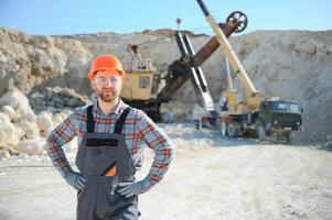 Extraction of stone. Male worker next to stone quarry. Engineer at construction site photo