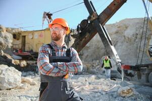 Male worker with bulldozer in sand quarry photo