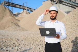 An engineer at a crushed stone or gravel plant. Stone mining photo