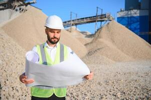 An engineer at a crushed stone or gravel plant. Stone mining photo