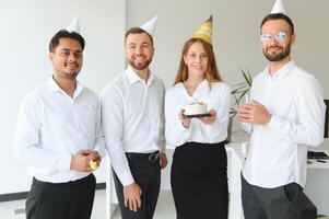 Business team celebrating a birthday of collegue in the modern office. photo