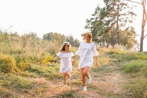 Mother and daughter having fun in the park. Happiness and harmony in family life. Beauty nature scene with family outdoor lifestyle. Mother's Day photo