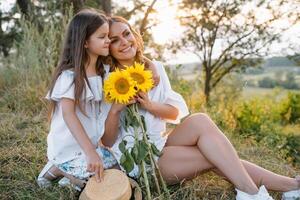 Mother and daughter having fun in the park. Happiness and harmony in family life. Beauty nature scene with family outdoor lifestyle. Mother's Day photo