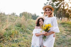 Mother and daughter having fun in the park. Happiness and harmony in family life. Beauty nature scene with family outdoor lifestyle. Mother's Day photo