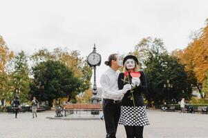 Mime on the street waiting to meet with his lover. Portrait of a mime comedian. mime on the street photo