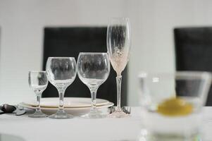 Glasses on the festive table setting. Wedding table decor concept. Table setting in classic style, setout. fine art. photo