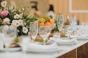Glasses on the festive table setting. Wedding table decor concept. Table setting in classic style, setout. fine art. photo