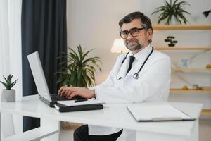 Doctor consulting patient using chat in clinic, view from web camera photo