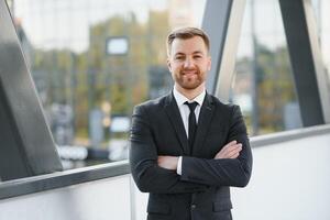 Portrait of a smiling businessman in a modern business environment photo