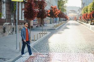 Blind man. People with disability, handicapped person and everyday life. Visually impaired man with walking stick. photo