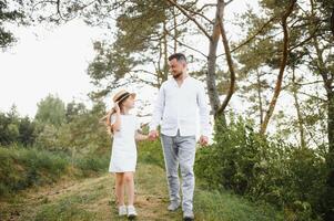stylish bearded father with his little daughter walk in the summer park. photo