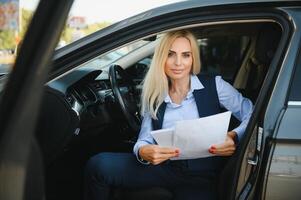 Portrait of business elegant middle-aged woman in car. photo