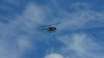 One helicopter flying over in the blue sky in autumn photo